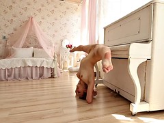 acrobatic hottie nino belover shows her skills near the piano