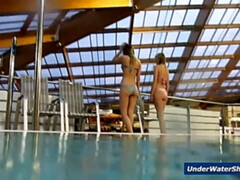 Horny girls strip eachother in the pool
