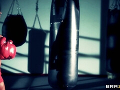 Boxer girl Aryana Augustine hitting the bag in the gym