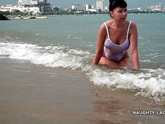 Naughty Russian MILF in White see thru swimsuit outdoors in public resort