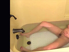 Cute lady in a tub struggles off painful contractions