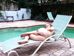 Little Scarlett Fall has fun with her body near the pool