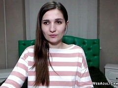 Hot European brunette babe laying dressed in bed