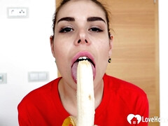Cute girl eats a banana and fingers herself