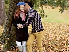 European red-haired girl sucking dick in a city park