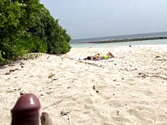 Exhibitionist wanks over busty MILF and her stepdaughter, leaving them with cum-covered faces under the sun