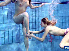 insane girls disrobe eachother in the pool